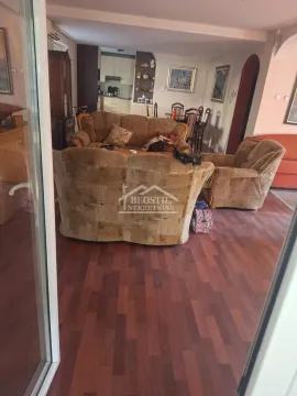 Living room with a sofa set and a view of the dining area and kitchen. - image 3