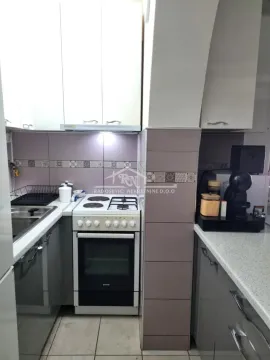 Small equipped kitchen with white units and a stove. - image 8
