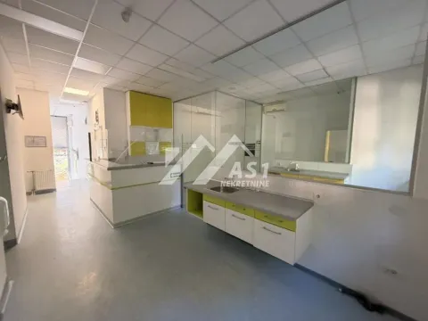Kitchen equipped with white and light green cabinets and a sink on the counter. - image 18