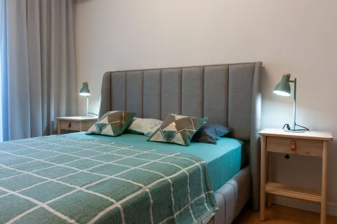 Furnished bedroom with a double bed, headboard, and nightstands. - image 16
