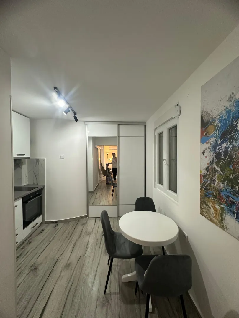 Small kitchen with a dining table and chairs.