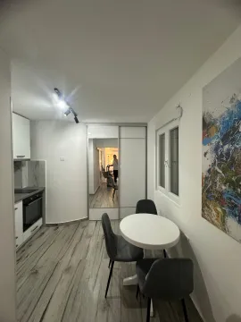 Small kitchen with a dining table and chairs. - image 6