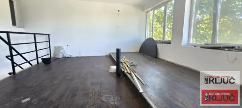 Empty room with dark flooring and large windows. - image 12