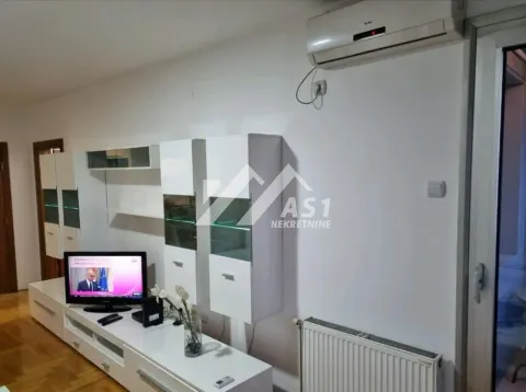 Living room with white furniture, television, and air conditioning. - image 9