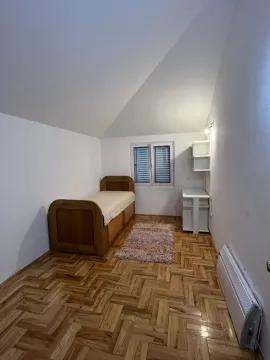 Manja spavaća soba sa drvenim krevetom, parketom i prozorom. - image 7
