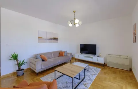 A bright living room with modern furniture and wooden floors. - image 6