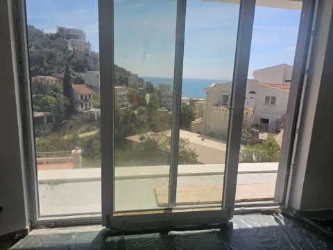 View of the sea and surrounding neighborhood through a large balcony glass door. - image 10
