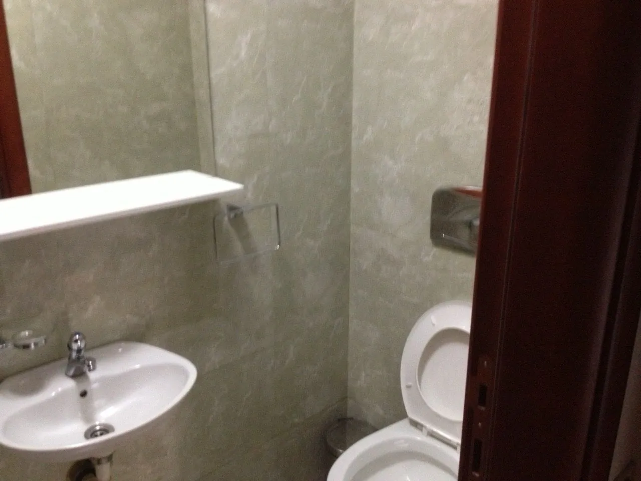 A small bathroom with a sink and toilet.