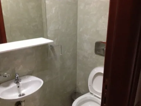 A small bathroom with a sink and toilet. - image 10