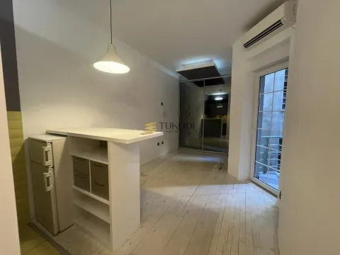 Smaller kitchen with a breakfast bar and balcony doors. - image 14
