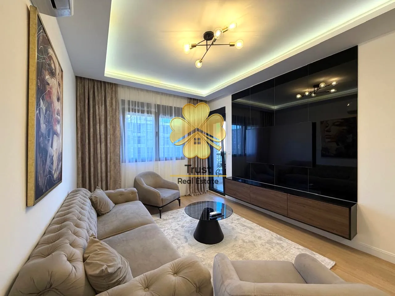 Modern and tidy living room with sofa set and large TV.