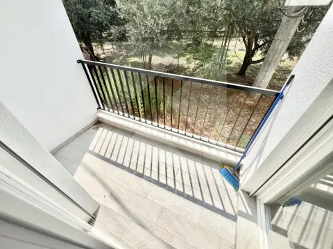 Small tiled balcony with railing and courtyard view. - image 9