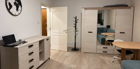 Furnished bedroom with a wardrobe, desk, and bed. - image 2