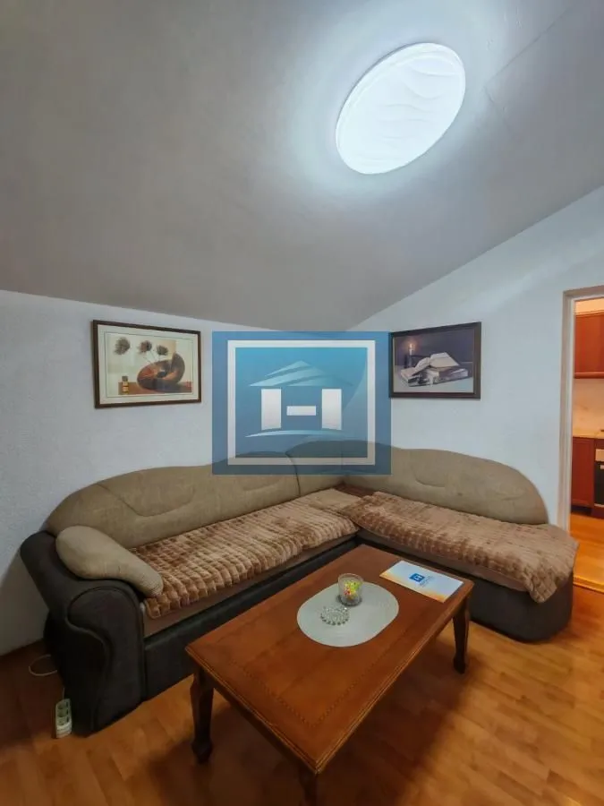 Living room with a corner sofa and a wooden coffee table.