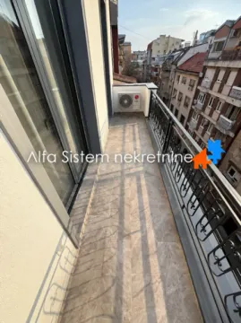 Narrow tiled balcony with metal railing and city view. - image 3