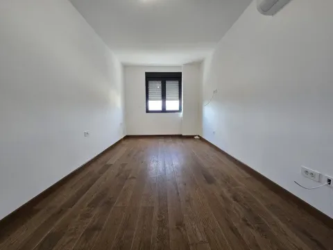 Empty room with white walls and wooden flooring. - image 17