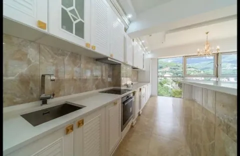 Modern kitchen with white cabinetry and a view of nature. - image 15