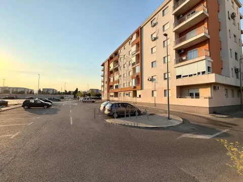 Exterior of an apartment building with parking and driveway. - image 9