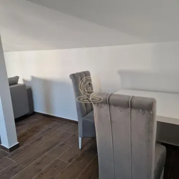 Part of the living room with a dining table and upholstered chairs under a sloped roof. - image 4