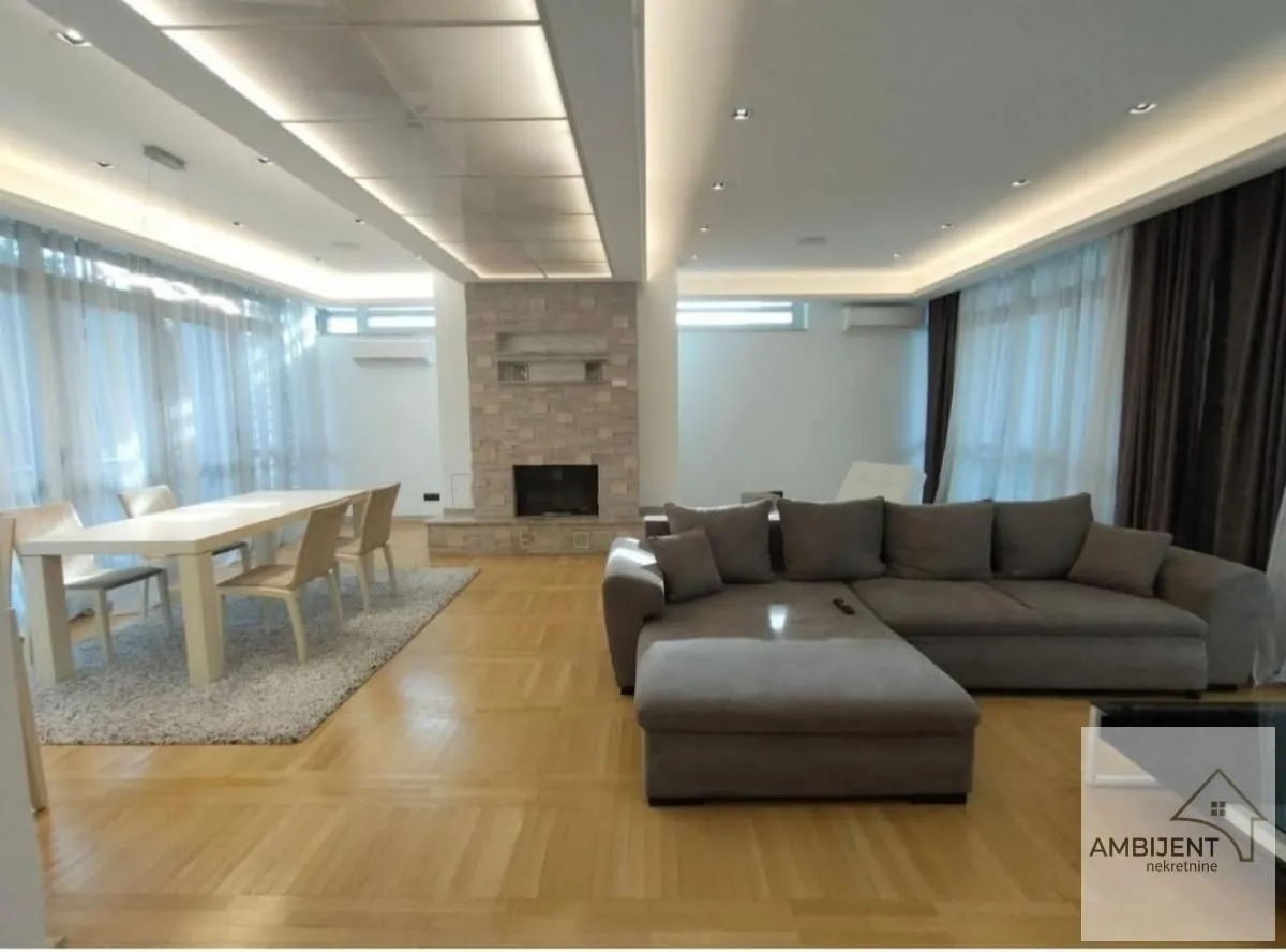 Spacious living room with a sofa set, dining area, and fireplace.