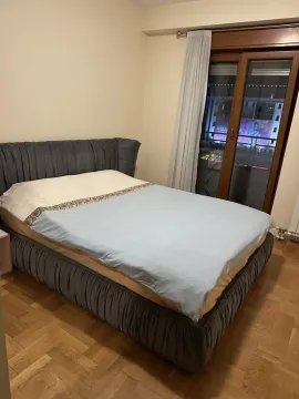 Spavaća soba sa bračnim krevetom i balkonskim vratima. - image 7
