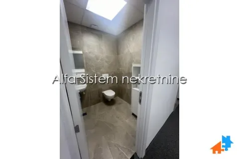 View through the doorway into a furnished bathroom with ceramic tiles and sanitaryware. - image 13