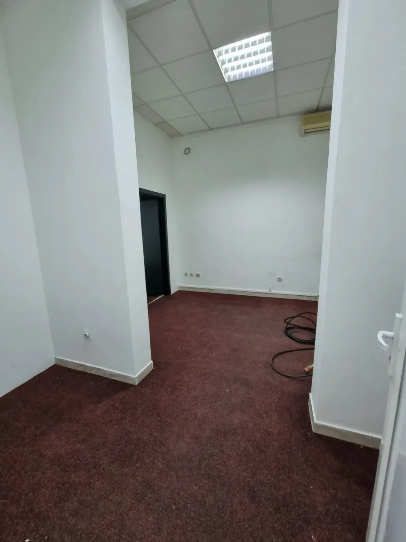 An empty room with red carpet.