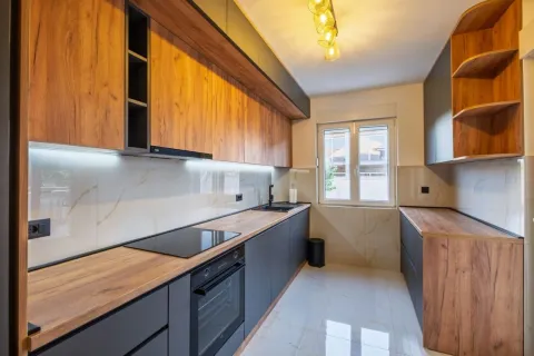 Modern kitchen with wooden elements and built-in appliances. - image 4