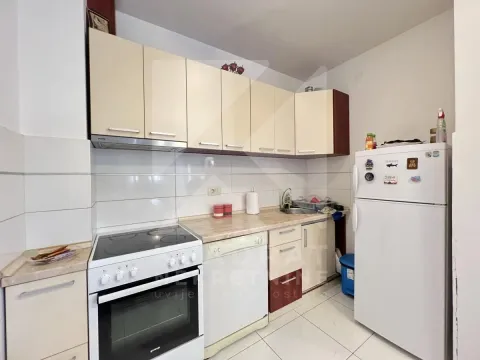 Compact kitchen with white cabinets, stove, and refrigerator. - image 5
