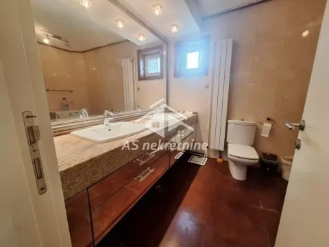 Bathroom with washbasin, large mirror, and toilet. - image 16