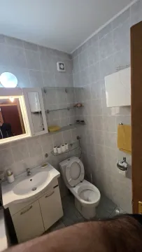 Bathroom with a sink and toilet. - image 8