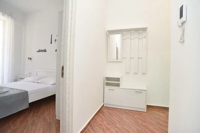 View from the hallway into the bright and neatly furnished bedroom area.