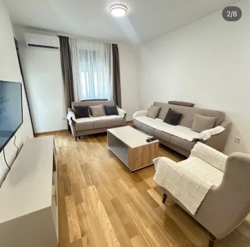 Living room with a sofa set, armchair, and TV unit. - image 2