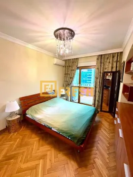 Bedroom with a double bed, wooden parquet flooring, and access to the terrace. - image 6