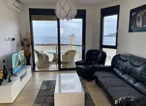 Living room with sofa, TV, and access to a terrace with a sea view. - image 10