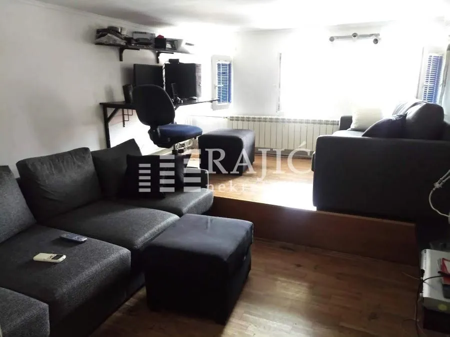 Living room with sofa set and a desk.