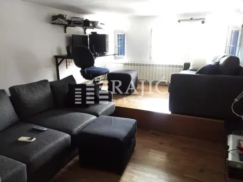 Living room with sofa set and a desk. - image 4