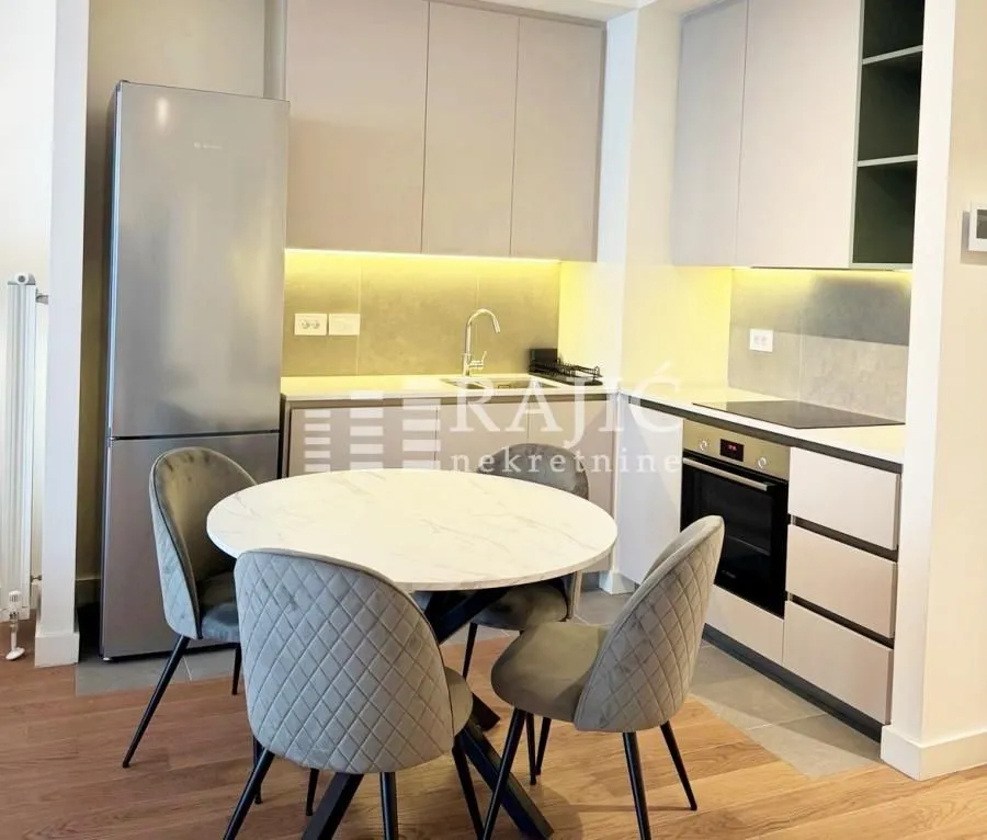 Modern kitchen with a dining table and chairs.