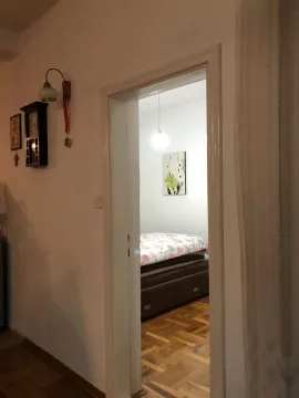 View through a doorway into a bedroom with a double bed. - image 17