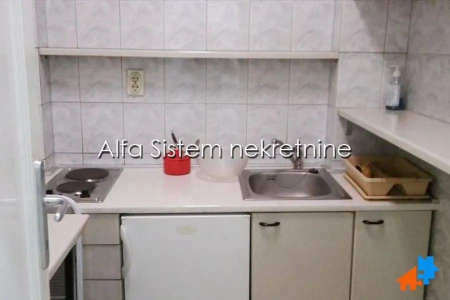 Smaller kitchen with a sink, electric hob, and lower cabinets.