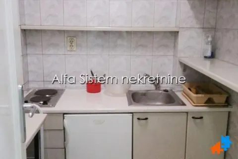 Smaller kitchen with a sink, electric hob, and lower cabinets. - image 5