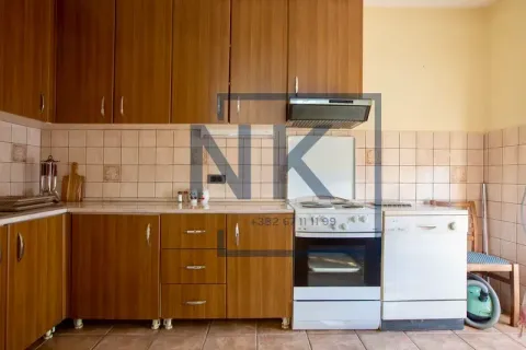 Kitchen with wooden cabinetry, a stove, and a dishwasher. - image 4