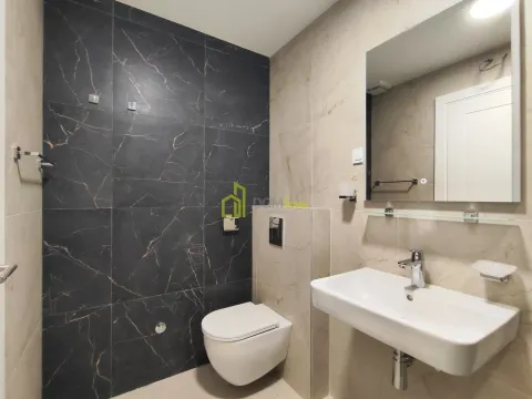 Modern bathroom equipped with a washbasin, toilet bowl, and mirror. - image 2