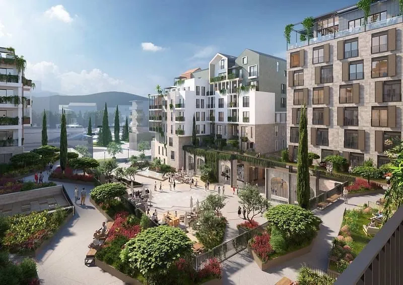Spoljašnji izgled modernog stambenog kompleksa sa uređenim dvorištem i šetalištem.