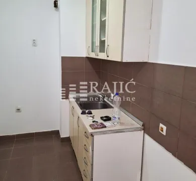 Smaller kitchen with cabinetry and sink. - image 3
