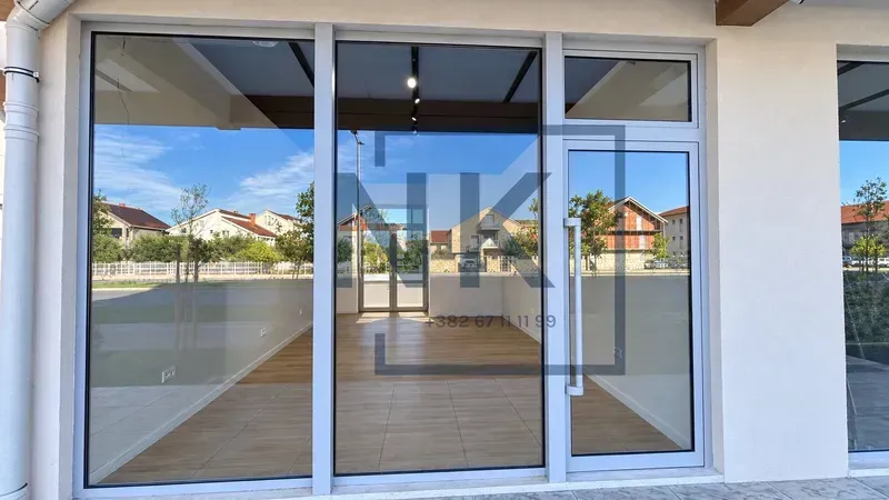 Exterior view of the commercial space with a large glass storefront and entrance door.