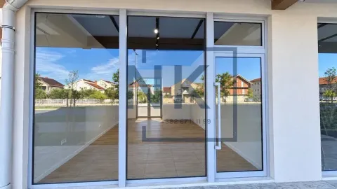Exterior view of the commercial space with a large glass storefront and entrance door. - image 4