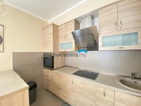 Modern kitchen with wooden elements and built-in appliances. - image 3