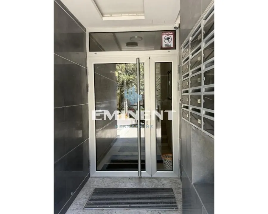 Building entrance with glass doors and mailboxes.