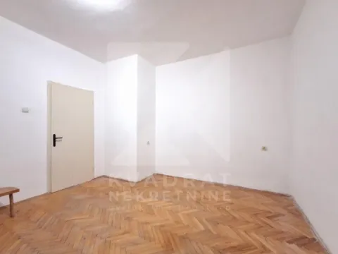 Empty room with white walls and wooden parquet flooring. - image 13